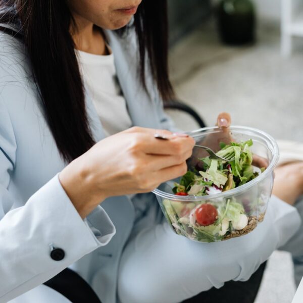 img of someone eating a salad